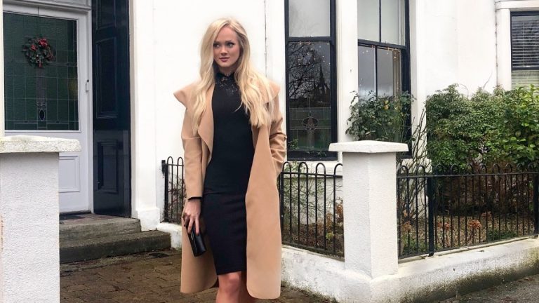 girl in camel coat in tree