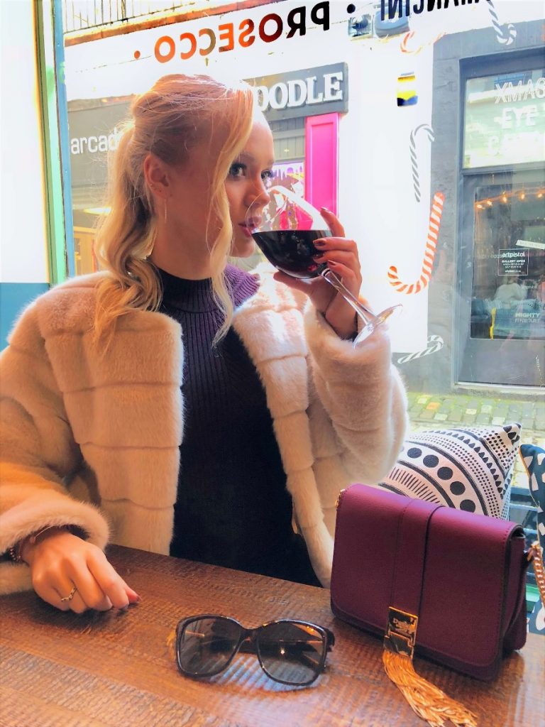 girl looking glamorous drinking wine