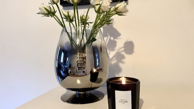 white roses with celine candle to romanticise your spring