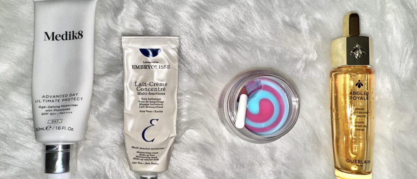 a selection of winter skincare routine products on a white fur background