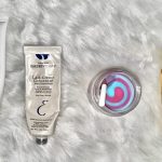 a selection of winter skincare routine products on a white fur background